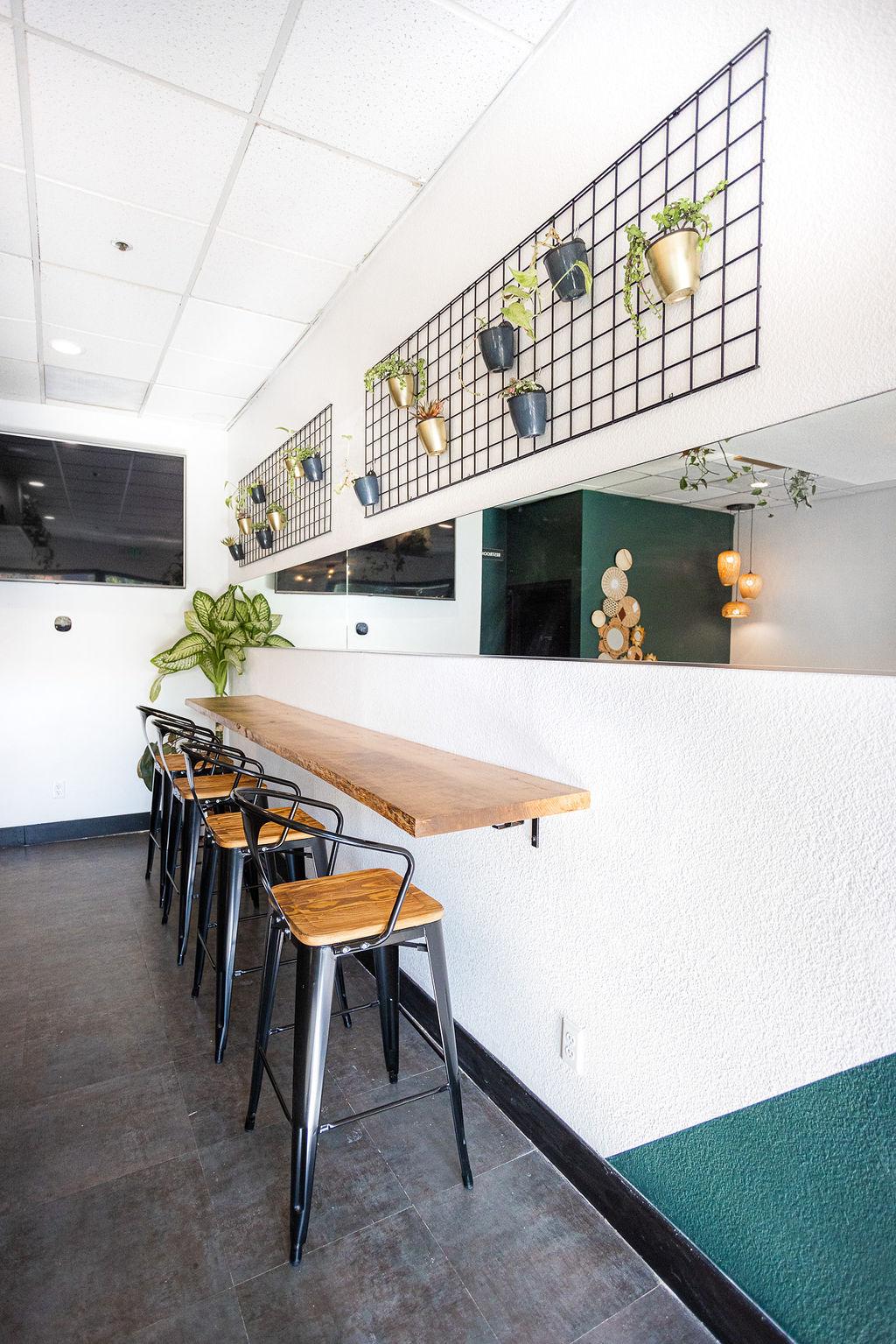 Bar seating and plant wall at Granite City Workspaces meeting area